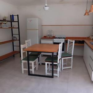 a kitchen with a table and chairs and a refrigerator at Posada San Pedro in Concordia +11 photos