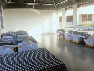 a room with blue and white tables and chairs at Hotel Vaishnavi Heights, Solapur in Bāle +30 photos