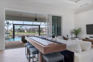 a living room with a pool table at SAN3337 Canalfront Vacation Pool Home in Punta Gorda