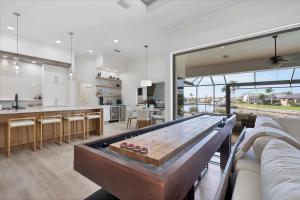 a large living room with a pool table at SAN3337 Canalfront Vacation Pool Home in Punta Gorda