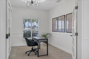 a desk in a room with a chair and a window at SAN3337 Canalfront Vacation Pool Home in Punta Gorda +31 photos