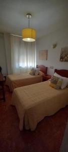 Postel nebo postele na pokoji v ubytování Hostal Las Cadenas