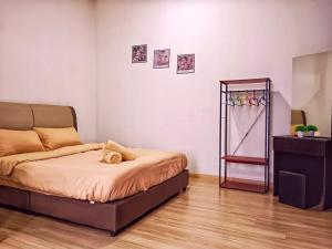 a bedroom with a bed and a dresser in it at Mount Austin HawKeLai in Johor Bahru