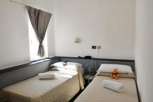 Postel nebo postele na pokoji v ubytování Hotel Le Palme
