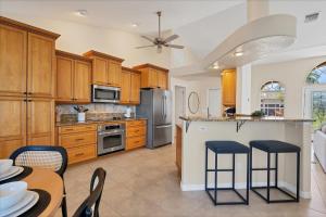 a kitchen with wooden cabinets and a table and chairs at GIC120 Punta Gorda Isles in Punta Gorda