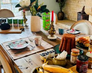 a wooden table with bananas and other food on it at Cottage de Flesselles in Flesselles