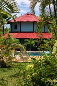 a house with a red roof and some trees at Casa Cielo in Pavones