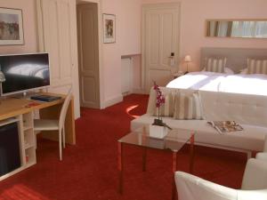 a hotel room with two beds and a television at Villa Toscane in Montreux