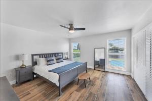a white bedroom with a bed and a table at MAD510 Punta Gorda Isles in Punta Gorda