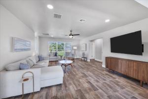 a living room with a white couch and a flat screen tv at MAD510 Punta Gorda Isles in Punta Gorda
