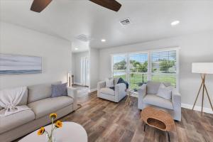 a living room with a couch and two chairs at MAD510 Punta Gorda Isles in Punta Gorda +20 photos