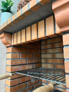 a brick oven with a rack on top of it at Amarelaje in Serra de El-Rei
