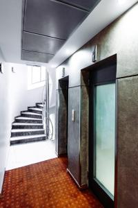 a hallway with stairs and a door in a building at Athens Mirabello in Athens