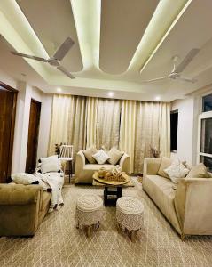 a living room with couches and a ceiling at Shelbys Abode in Dehradun
