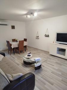 a living room with a couch and a table at Séjourner chez Roto in Cambronne-lès-Ribécourt