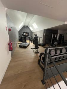 a gym with treadmills and exercise equipment in a room at Bungalow convivial à Saint-Arnoult avec piscine in Saint-Arnoult