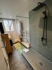 a bathroom with a shower with a glass wall at MX - House 10 min PARIS EXPOS- 11 bedrooms - in Malakoff +66 photos