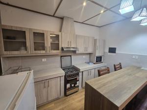 a kitchen with wooden cabinets and a stove top oven at cite blanche in Bangui