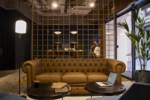 a living room with a couch and a table with a laptop at Letoh Letoh Bilbao in Bilbao