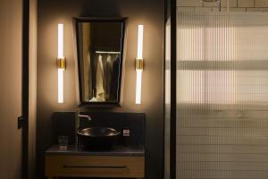a bathroom with a sink and a mirror and a shower at Letoh Letoh Bilbao in Bilbao