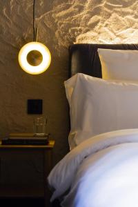 a bedroom with a bed and a lamp on a table at Letoh Letoh Bilbao in Bilbao
