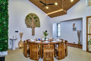 a dining room with a table and chairs at SaffronStays Eagle's Span in Malavli