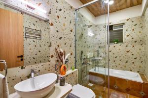 a bathroom with a sink and a shower at SaffronStays Eagle's Span in Malavli +10 photos