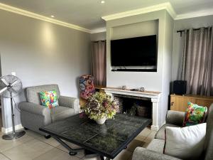 a living room with a table and chairs and a television at Laid-Back Tortoise in Fisherhaven