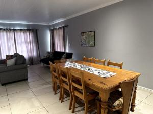 a dining room with a wooden table and chairs at Laid-Back Tortoise in Fisherhaven