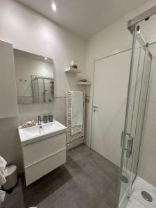 a white bathroom with a sink and a shower at New apartment-Sotto la Torre in Monsummano +52 photos