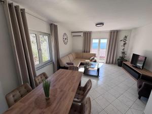 a living room with a table and a couch at Apartment Tribanj Florida in Viniština