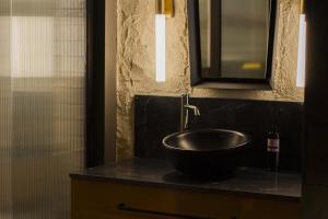 a bathroom with a bowl sink on a counter at Letoh Letoh Bilbao in Bilbao
