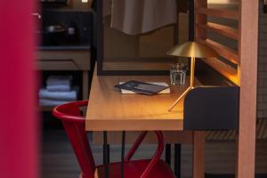 a wooden table with a lamp and a glass on it at Letoh Letoh Bilbao in Bilbao