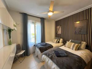 A bed or beds in a room at La Torre Golf Resort