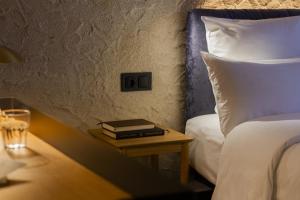 a bedroom with a bed and a table with books at Letoh Letoh Bilbao in Bilbao