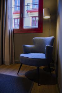 a blue chair sitting in front of a window at Letoh Letoh Bilbao in Bilbao