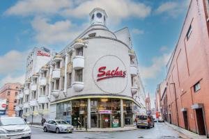a building on a street with cars parked in front of it at Sachas Hotel Manchester in Manchester