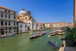 a group of boats in a river with buildings at View of Grand Canal Luxury Home - Station 5 minutes in Venice