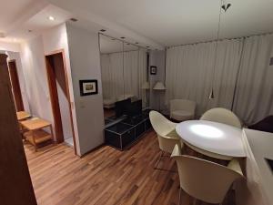 a living room with a white table and chairs at Elegant, Suite, Swimming Pool in Wiesbaden