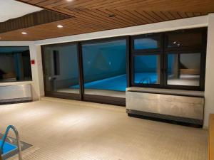 a room with large windows and a view of the ocean at Elegant, Suite, Swimming Pool in Wiesbaden