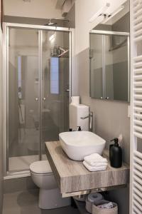 a bathroom with a sink and a toilet and a shower at Moss & Stone - 3 min walk to piazza Vittoria in Brescia +17 photos