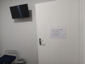 a door with a sign on it next to a chair at Ongerup Hotel in Ongerup