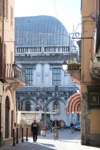 a building with a glass dome in the middle of a street at Moss & Stone - 3 min walk to piazza Vittoria in Brescia