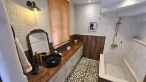 a bathroom with a sink and a mirror and a tub at Cottage Aegean Holiday Villa in Bayırköy