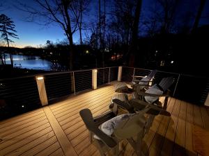 a deck with chairs and a view of the water at High Rock Haven in Lexington