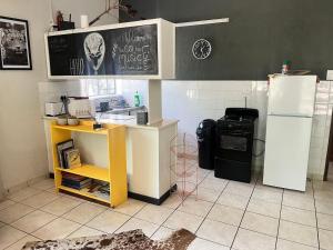 a kitchen with a refrigerator and a counter with a stove at Hello Kruger Hideaway in Marloth Park