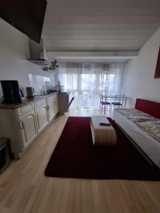 a living room with a bed and a kitchen at Exclusive Apartments in Bietigheim-Bissingen +6 photos