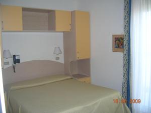 Postel nebo postele na pokoji v ubytování Hotel Ariella