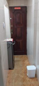 a small bathroom with a door and a toilet at Apartamento estilo flat em Copacabana in Rio de Janeiro +15 photos
