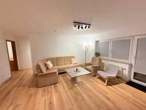 a living room with a couch and a table at Casa Grande mit 3 Apartments in Rastatt